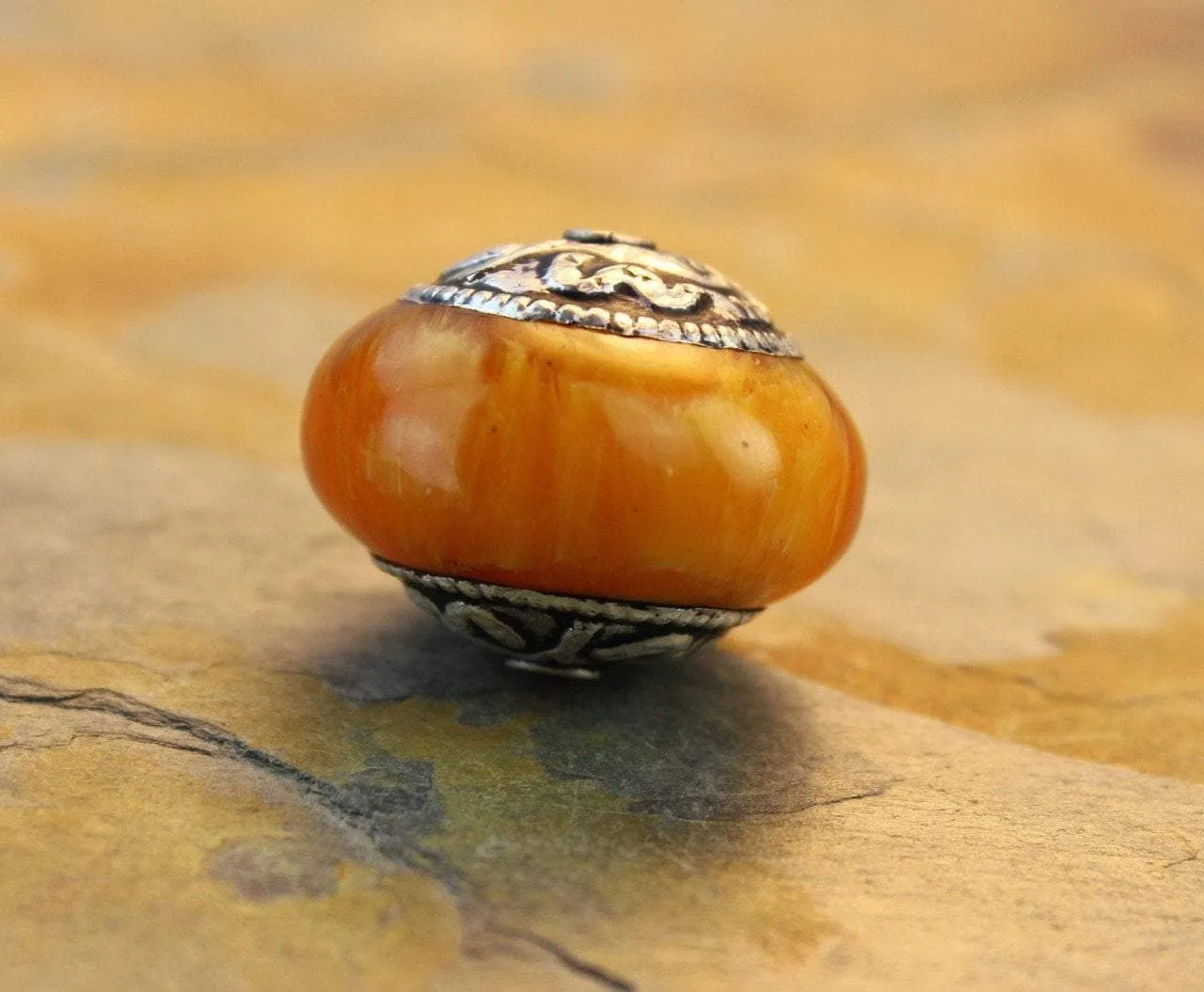 Conch Capped Tibetan Copal Bead