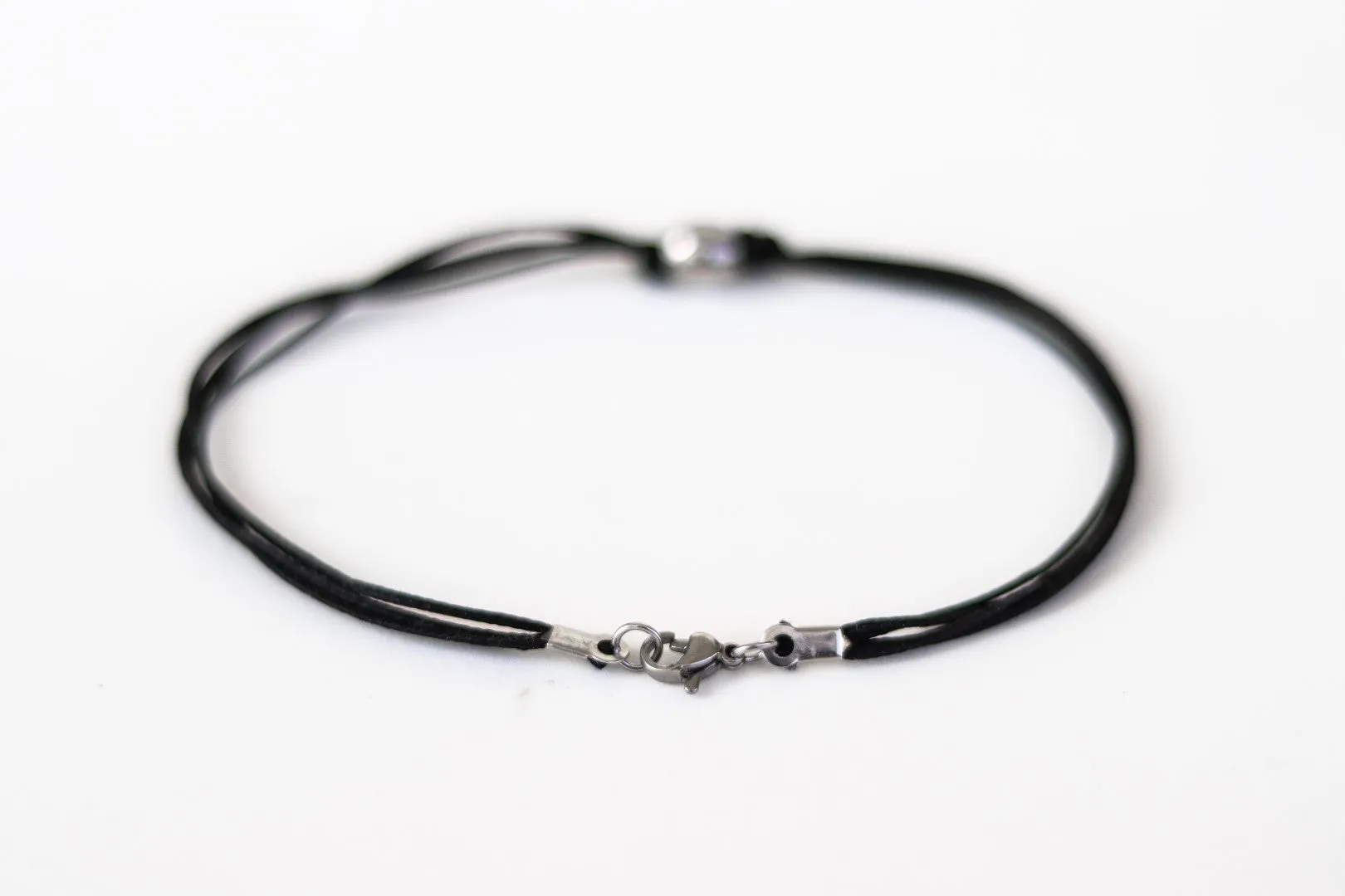 Men's anklet with a stainless steel waterproof bead and a black cord