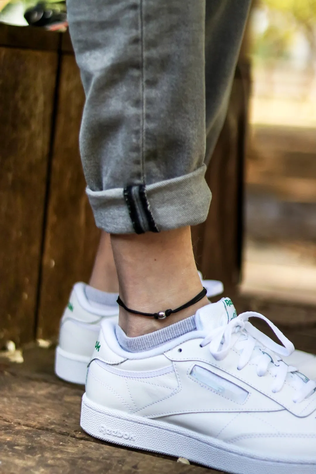 Men's anklet with a stainless steel waterproof bead and a black cord