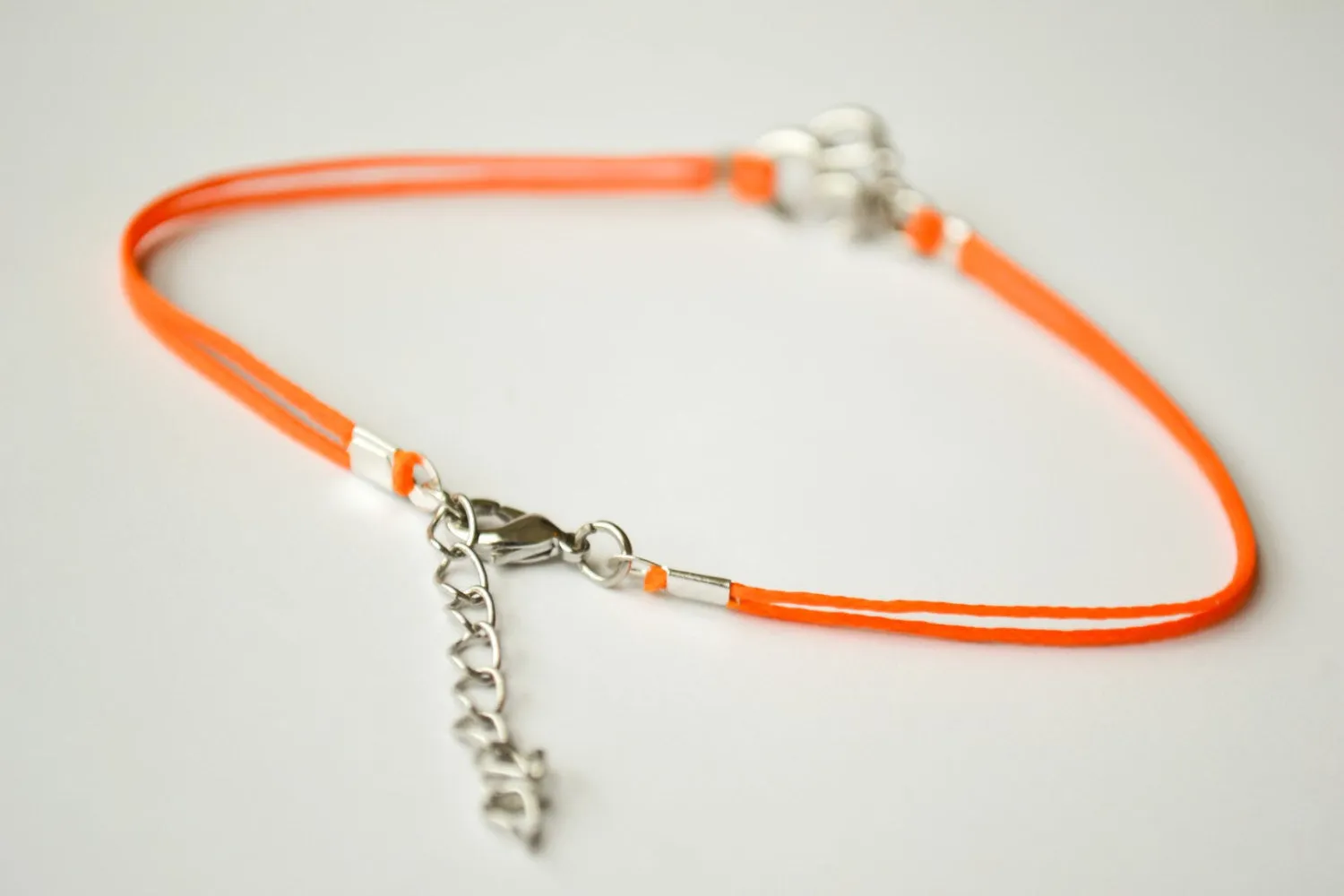 Orange cord anklet with silver Om charm, yoga jewelry